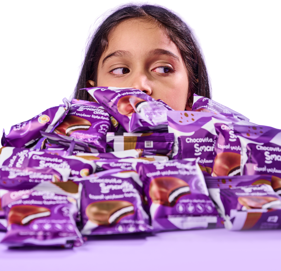 Girl surrounded by Chocovita Snacks Fortified with vitamins, Minerals and Omega 3