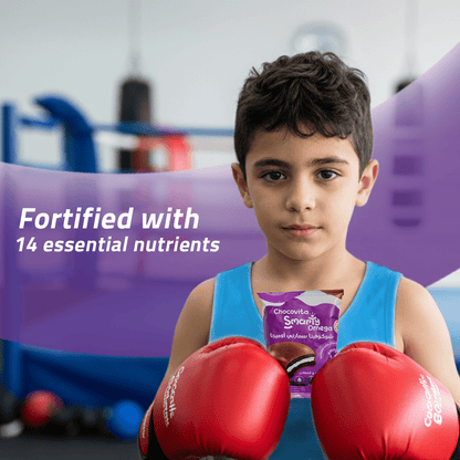 Child in boxing gloves holding a Vitamin-fortified Marshmallow Chocolate Sandwich in a gym setting. 